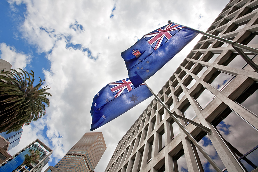Australian flags waving on building 
