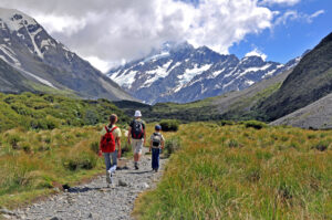 Family hiking toward Mount Cook, South Island, New Zealand